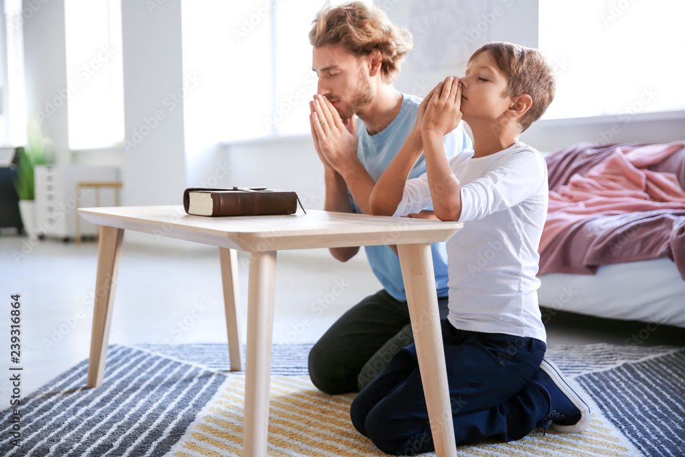 Fototapeta premium Father with son praying at home