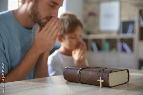 Father with son praying at ...