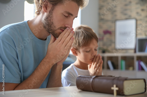 Father with son praying at home