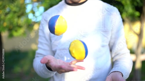 A young man juggling in the garden