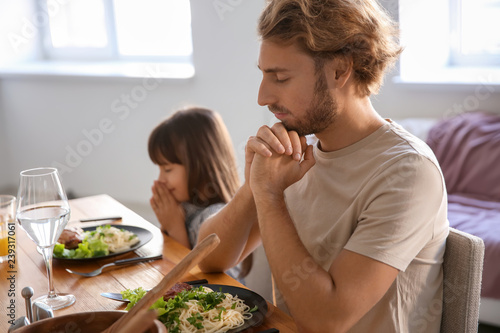 Father with daughter prayin...