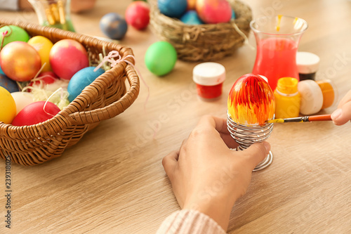 Woman painting Easter eggs ...