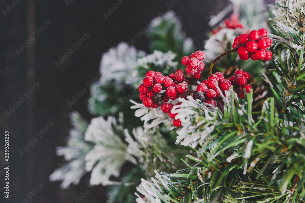 detail of small Christmas tree with snow mistletoe and pine cone decorations,