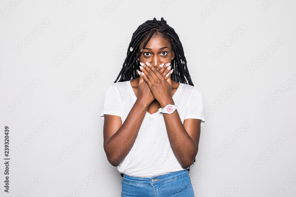 Close up portrait of upset scared black woman, covering her mouth with both palms to prevent screaming sound, after seeing or hearing something bad. Negative emotions, facial expressions and feelings Close up portrait of upset scared black woman, covering her mouth with both palms to prevent screaming sound, after seeing or hearing something bad. Negative emotions, facial expressions and feelings