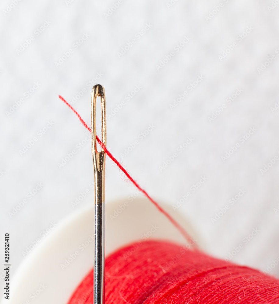 Thread the needle . Needle for sewing Red spool . Thread the needle . Needle for sewing Red spool .