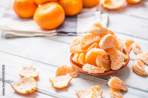 Fresh pieces of tangerines mandarin on the plate or in a bowl