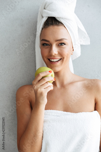 Beautiful young woman wrapped in a bath towel