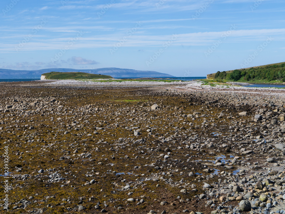 ireland's coastline with pebble beach and mountains in the background ireland's coastline with pebble beach and mountains in the background