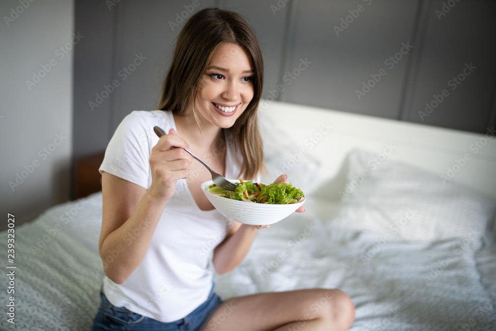 Beautiful woman eating healthy fresh organic salad Beautiful woman eating healthy fresh organic salad