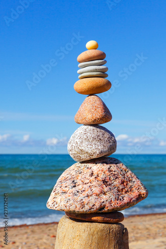 Gray and red zen stones on the background of the sea. Concept of harmony  balance and meditation.