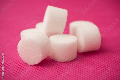 closeup of sugar in shaped circle on pink background