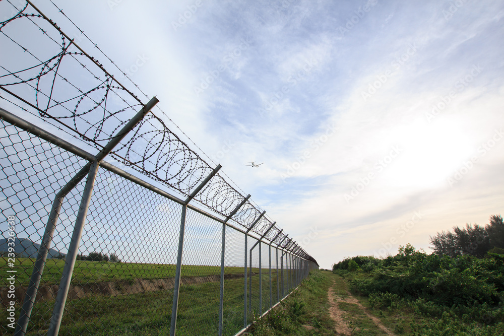 Chain link fence with grass field Phuket International Airport