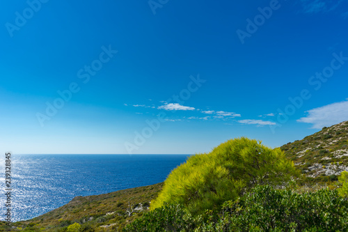 Greece, Zakynthos, Blue sky and blue ocean in contrast to green nature landscape