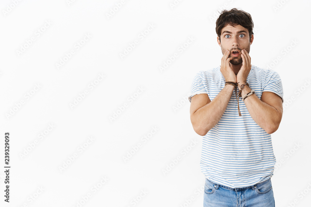 Portrait of shcoked nervous and stunned young masculine male with blue