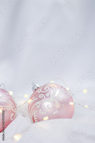 Pink Christmas balls in front of a white background (portrait) 