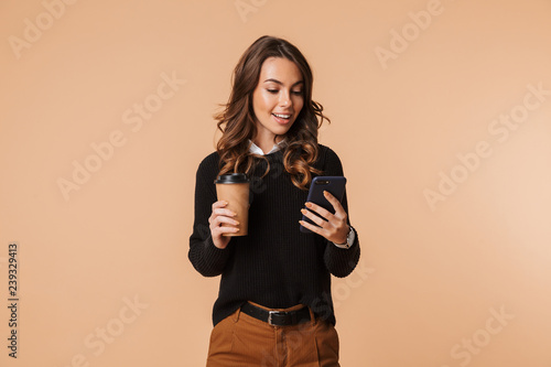 Smiling young woman wearing sweater standing