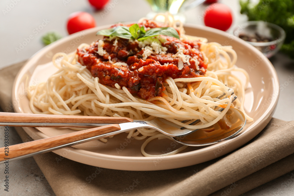 Plate with delicious pasta bolognese on grey table Plate with delicious pasta bolognese on grey table