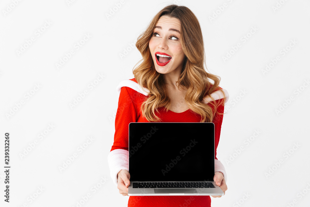 Pretty excited woman in christmas costume showing display of laptop computer. Pretty excited woman in christmas costume showing display of laptop computer.