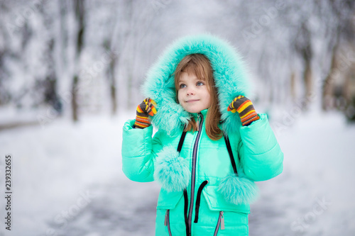 Beautiful portrait of little child enjoying winter