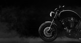 Black motorcycle detail on a dark background with smoke, side view (3D illustration)