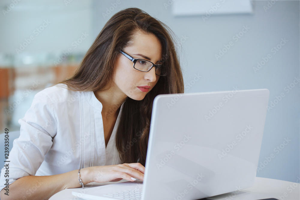Businesswoman with a laptop in the office. Businesswoman with a laptop in the office.