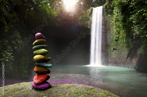 Serenity, tranquility and calm stillness in nature, stones stacked near a tropical waterfall photo