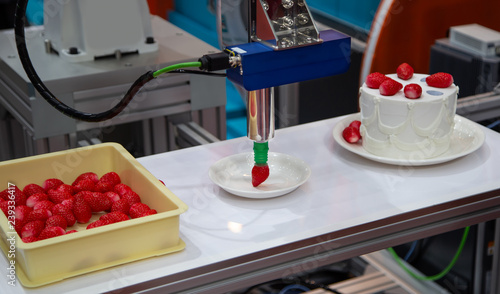 Demonstration of robot topping strawberry on cake