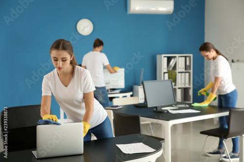 Team of janitors cleaning o...