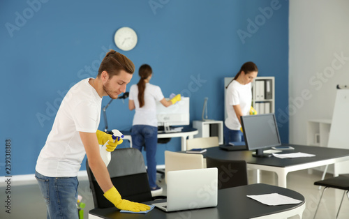 Team of janitors cleaning o...