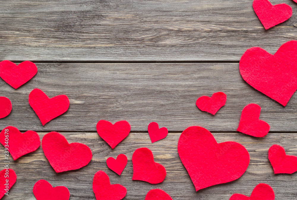 Frame from hearts carved from red felt on the wooden background. Love and romance concept. Copy space, top view, flat lay Frame from hearts carved from red felt on the wooden background. Love and romance concept. Copy space, top view, flat lay