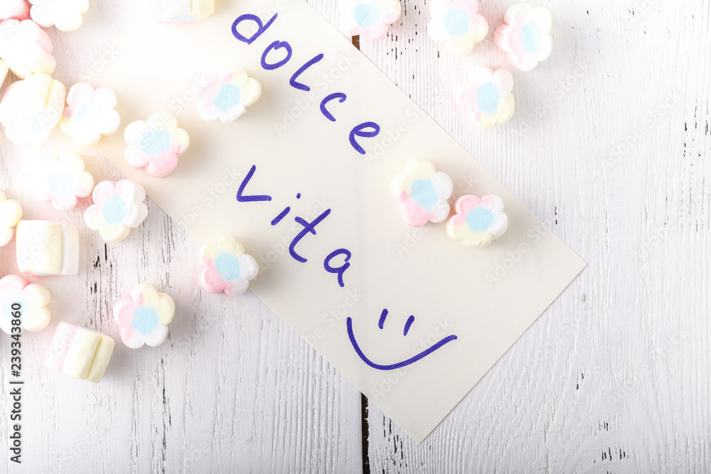 Multicolored marshmallows with notes on paper sweets Multicolored marshmallows with notes on paper sweets