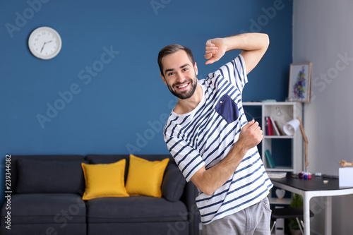 Handsome young man dancing at home