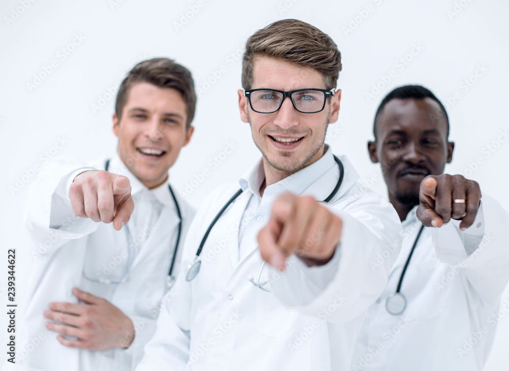group of successful doctors pointing to you. group of successful doctors pointing to you.