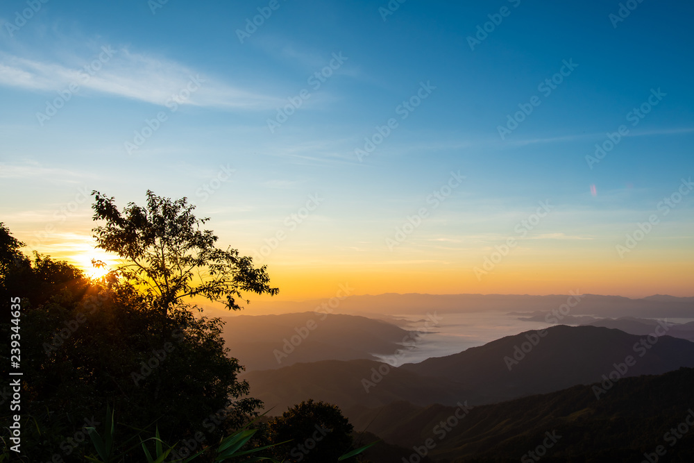 Obraz premium Foggy on the mountain at sunset.