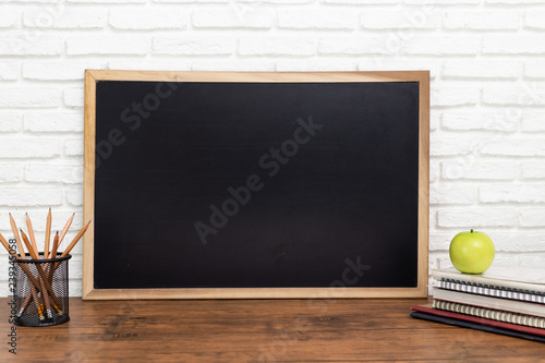 blackboard and a pencil on wooden background