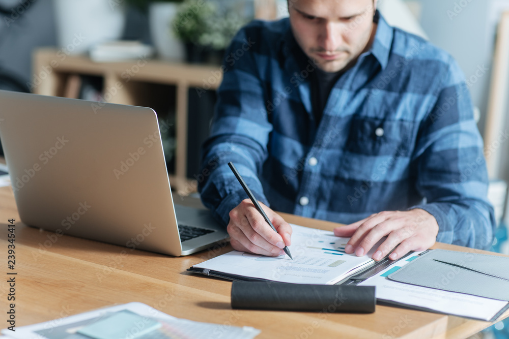 Modern Businessman Writing at His Office Modern Businessman Writing at His Office