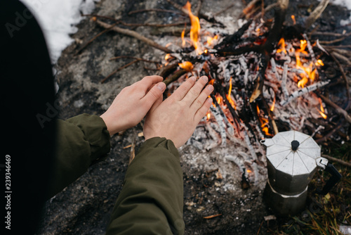 Wallpaper Mural Girl in the hat warms hands near a fire in winter. Concept adventure active vacations outdoor. Winter camping Torontodigital.ca
