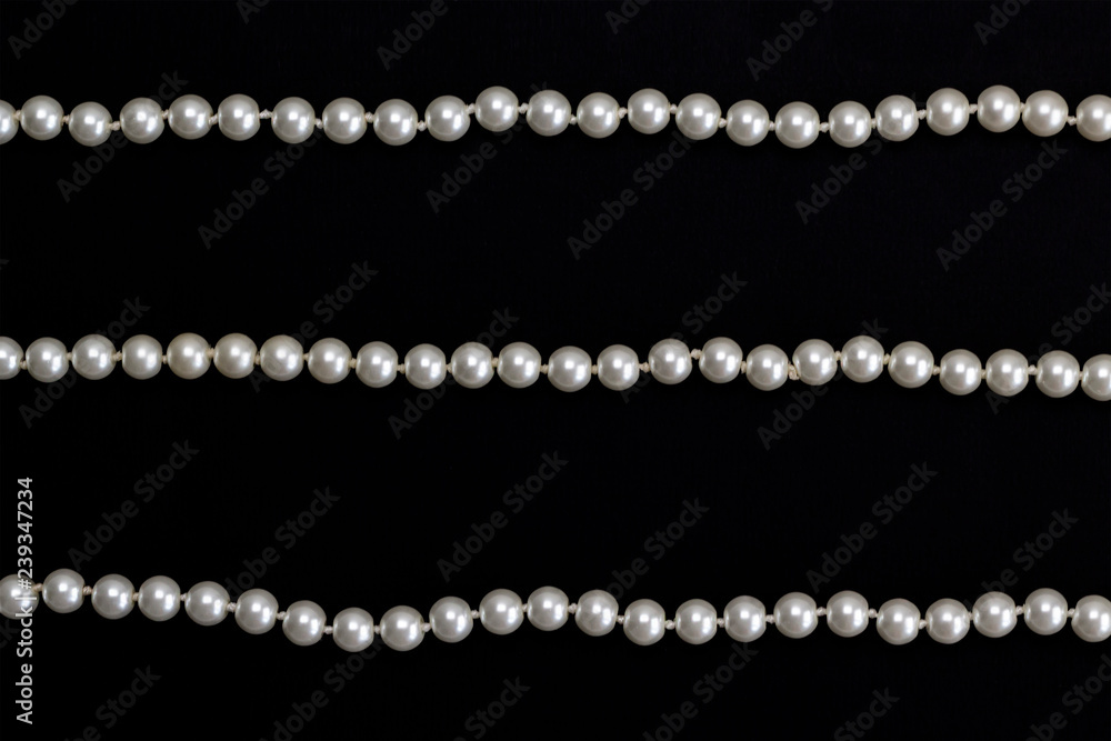 Rows of pearl necklace on the black 
