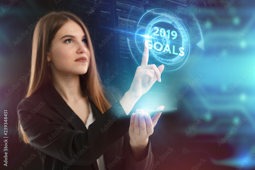 The concept of business, technology, the Internet and the network. A young entrepreneur working on a virtual screen of the future and sees the inscription: 2019 goals The concept of business, technology, the Internet and the network. A young entrepreneur working on a virtual screen of the future and sees the inscription: 2019 goals