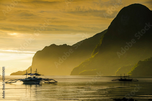 Outrigger at sunset in the bay of El Nido, Bacuit Archipelago, Palawan, Philippines, Southeast Asia, Asia