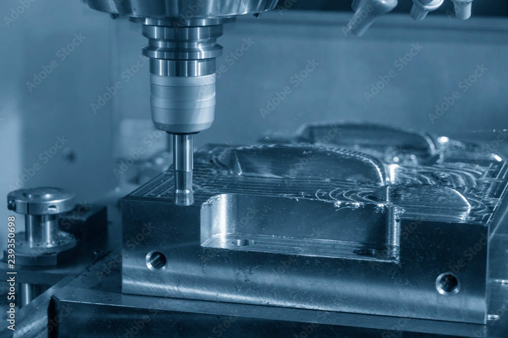 The operation of CNC milling machine .The CNC milling machine cutting the mold part with the index-able radius end mill tool in roughing process. The operation of CNC milling machine .The CNC milling machine cutting the mold part with the index-able radius end mill tool in roughing process.
