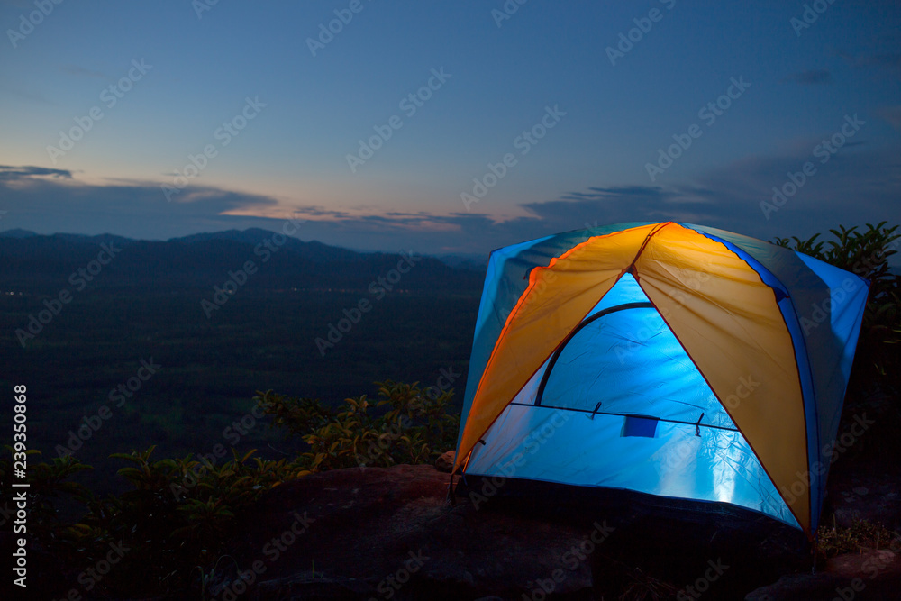 Aerial view tent camping and is lighting in the tent after sunset.