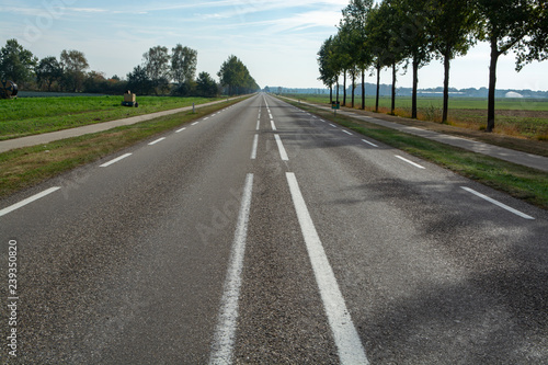 Road network in Netherlands, high quality roads in countryside, landscape with fields, road and bicycle line
