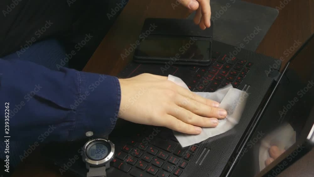 Man Wipes His Laptop Keyboard Man Wipes His Laptop Keyboard