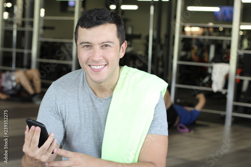 Ethnic man using fitness app with copy space