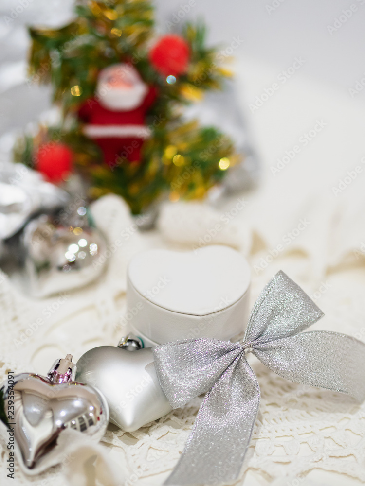 White gift small box with Christmas decorations. Selective focus. New Year's composition close-up view. White gift small box with Christmas decorations. Selective focus. New Year's composition close-up view.