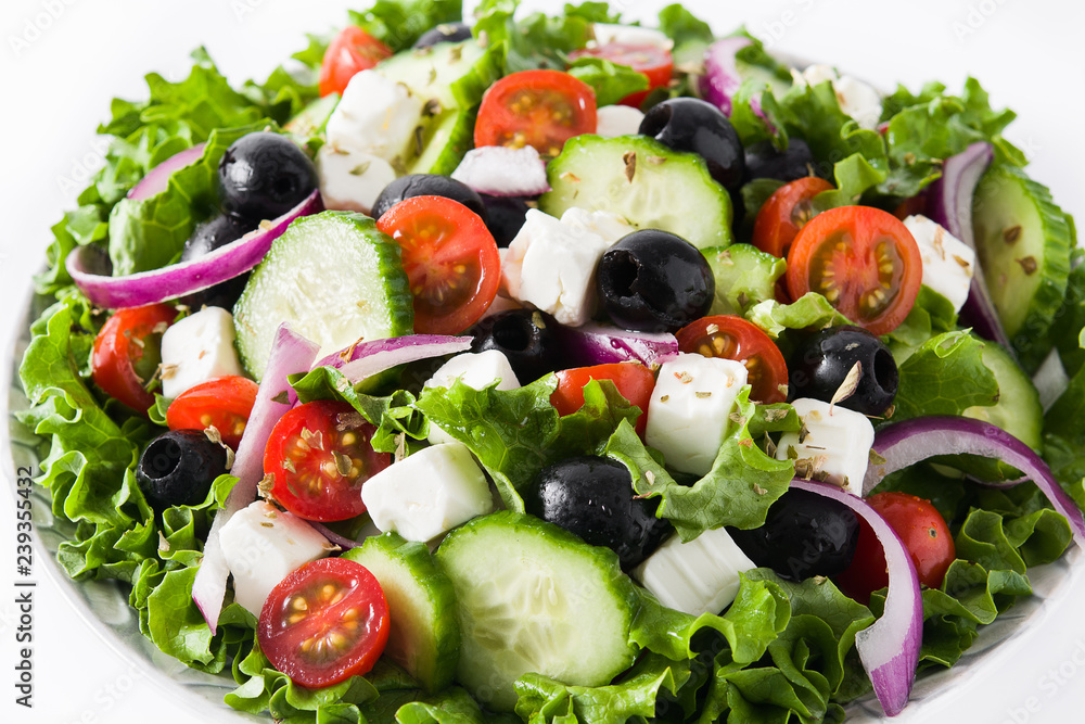 Fresh Greek salad in Plate with black olive,tomato,feta cheese, cucumber and onion isolated on white background. Fresh Greek salad in Plate with black olive,tomato,feta cheese, cucumber and onion isolated on white background.