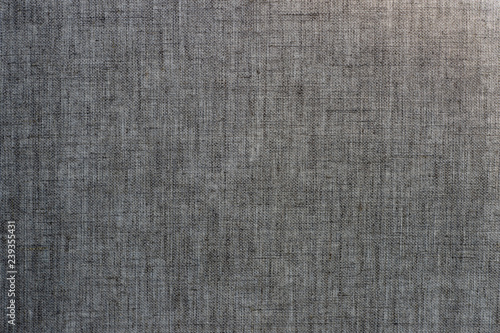 Canvas of linen grey fabric, with a rough gradient of illumination. Textured background