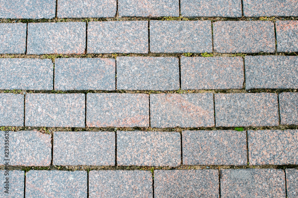 Granite pavement of the old part of the city. Background, texture Granite pavement of the old part of the city. Background, texture