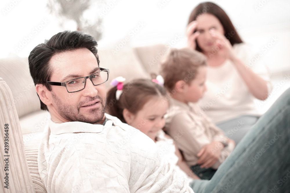 close up.parents play with their children sitting on the couch